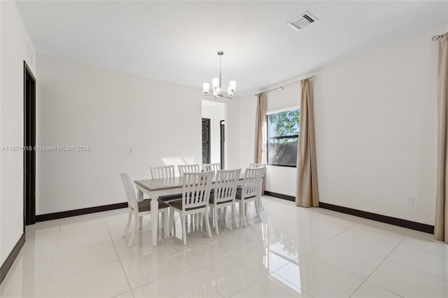 dining area with an inviting chandelier and light tile patterned floors