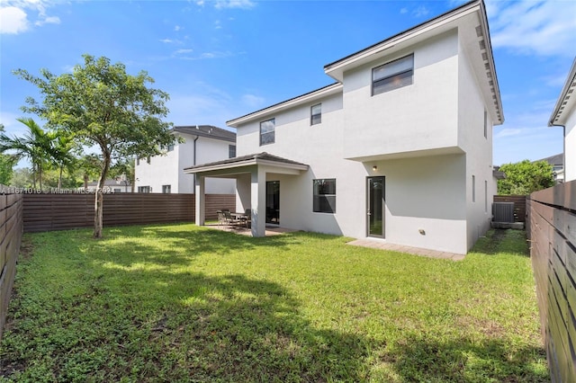 rear view of property with a patio and a yard