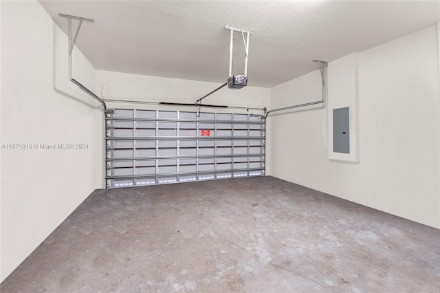 garage featuring electric panel and a garage door opener