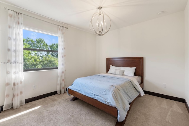 carpeted bedroom featuring a chandelier