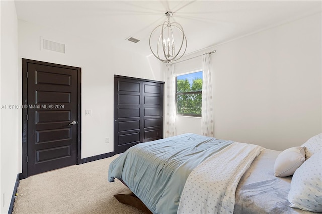 bedroom featuring carpet floors and a notable chandelier