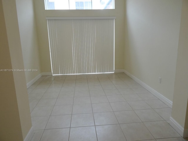 tiled spare room with plenty of natural light