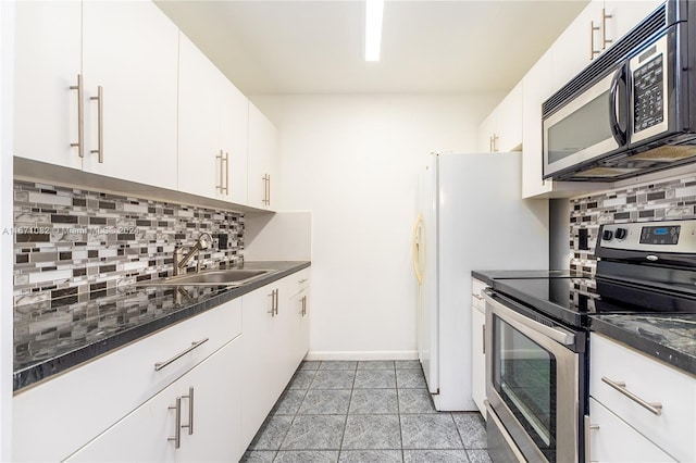 kitchen featuring tasteful backsplash, sink, white cabinetry, appliances with stainless steel finishes, and light tile patterned floors