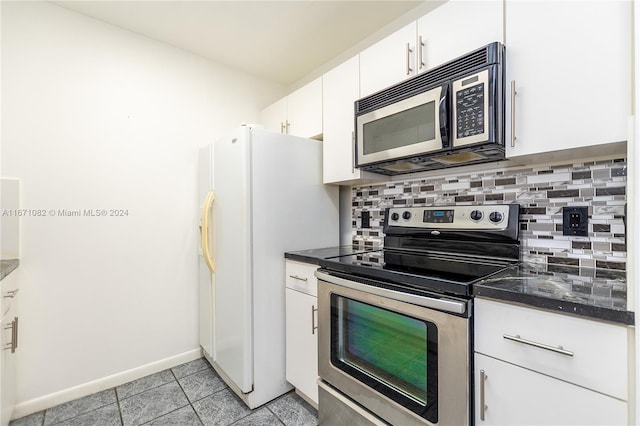 kitchen featuring light tile patterned flooring, white cabinetry, stainless steel appliances, and backsplash