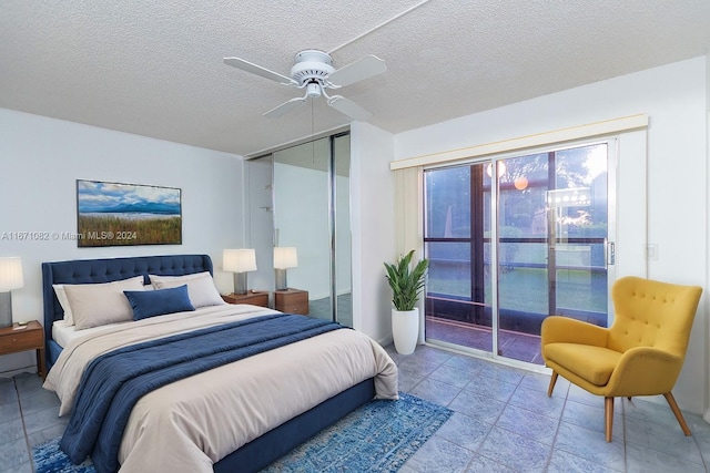 tiled bedroom with ceiling fan, a textured ceiling, and a closet