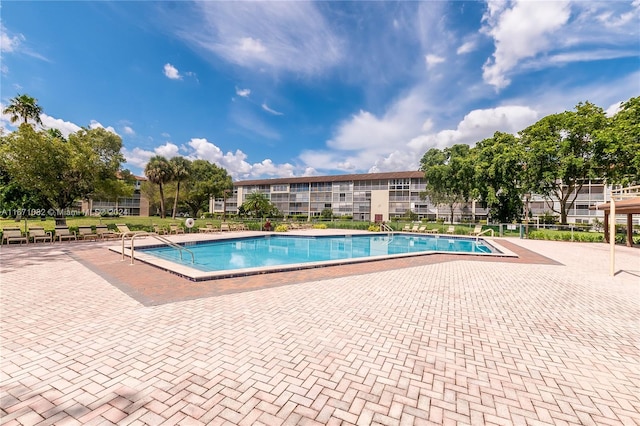 view of swimming pool with a patio