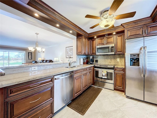 kitchen featuring crown molding, a sink, ceiling fan with notable chandelier, decorative backsplash, and stainless steel appliances