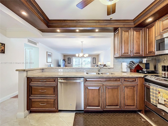 kitchen with crown molding, a sink, ceiling fan with notable chandelier, appliances with stainless steel finishes, and visible vents
