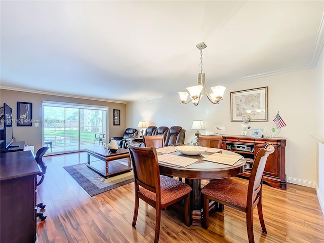 dining room with baseboards, ornamental molding, a chandelier, and light wood finished floors