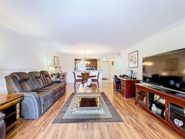 living area featuring visible vents, light wood-style floors, and crown molding