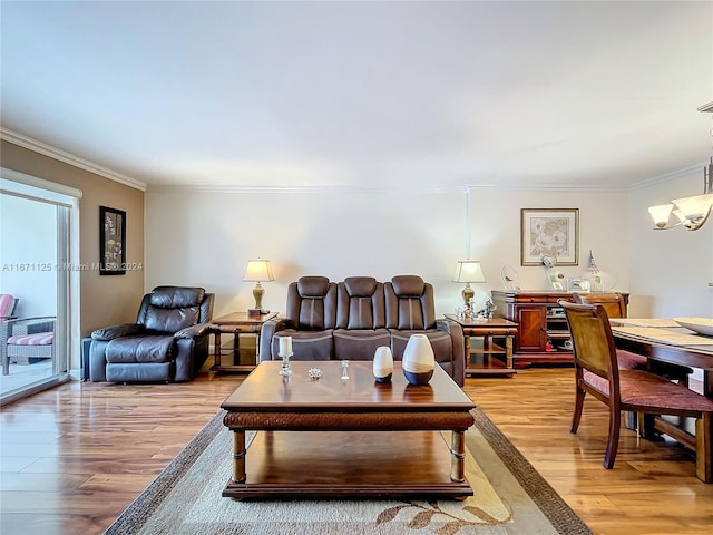 living area with light wood-style flooring, a notable chandelier, and ornamental molding