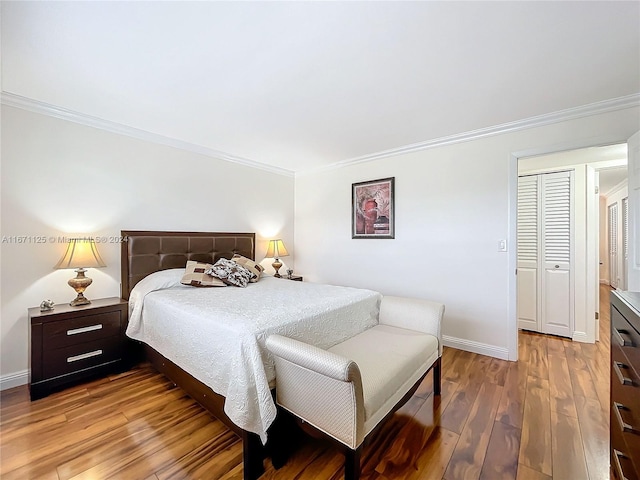 bedroom featuring baseboards, ornamental molding, and light wood-type flooring
