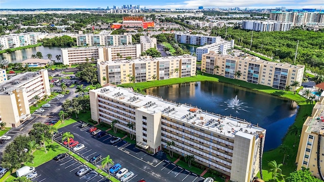 drone / aerial view with a city view and a water view