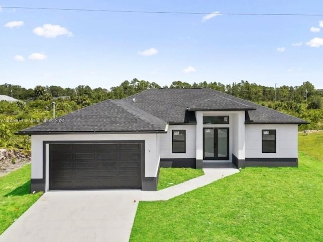 view of front of house featuring a front yard and a garage