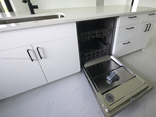 kitchen featuring sink and white cabinets