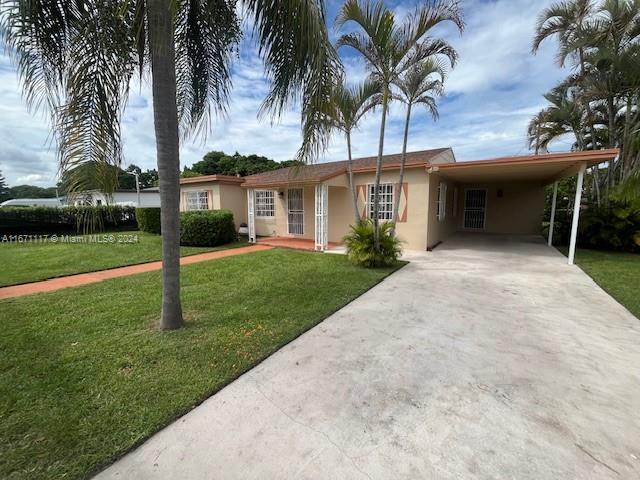 ranch-style house featuring a front yard and a carport