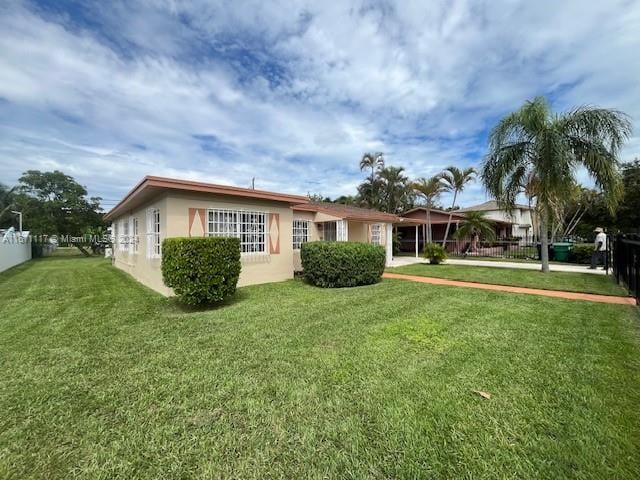 rear view of house with a yard