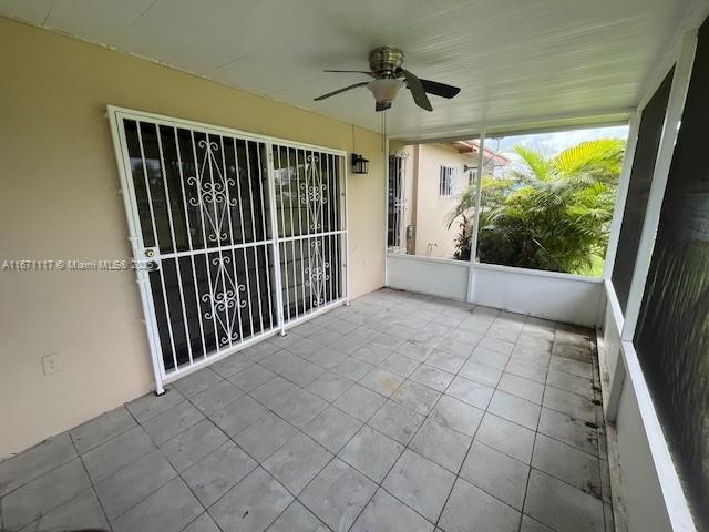 unfurnished living room with tile patterned flooring, ceiling fan, and a fireplace