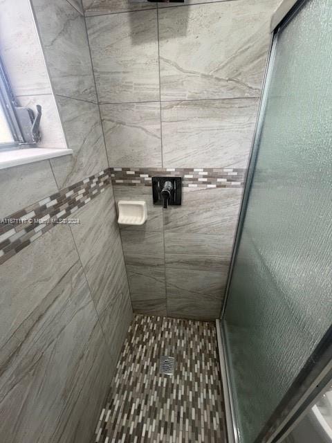 bathroom featuring an enclosed shower