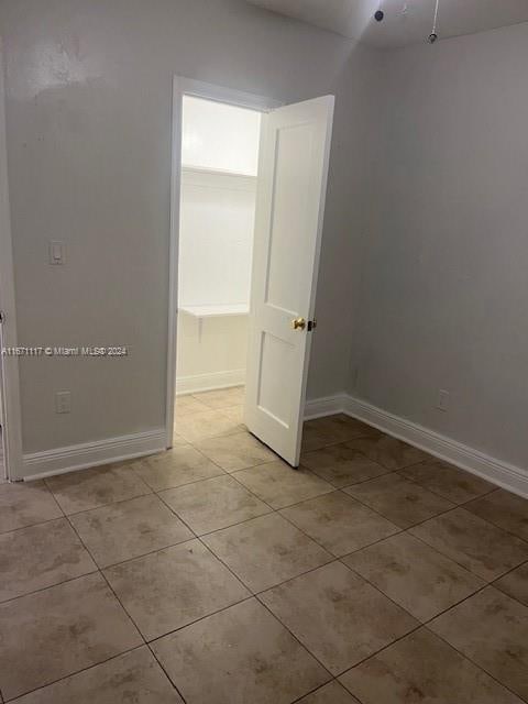 spare room featuring light tile patterned floors