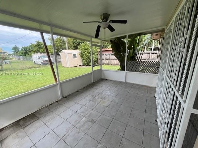 unfurnished sunroom with ceiling fan