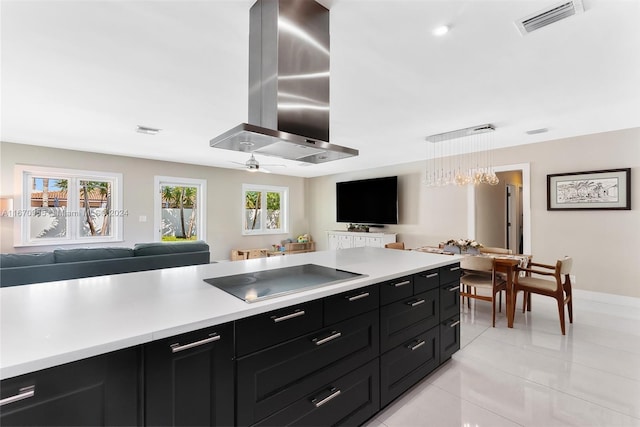 kitchen featuring pendant lighting, black electric stovetop, wall chimney exhaust hood, ceiling fan, and light tile patterned flooring