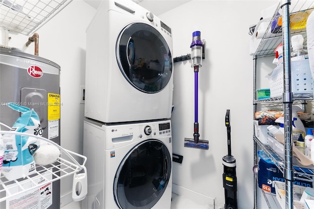 laundry room with water heater and stacked washer and clothes dryer