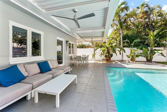 view of pool with an outdoor living space and a patio area