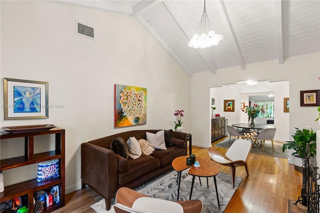 living room featuring a notable chandelier, beamed ceiling, and hardwood / wood-style flooring