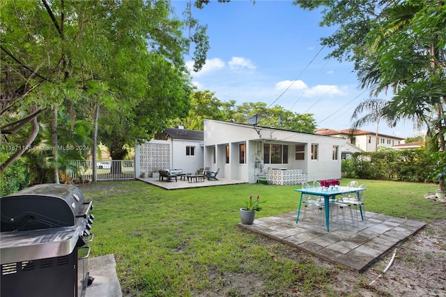 back of house with a lawn and a patio