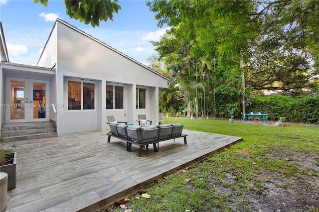 rear view of property with french doors, an outdoor hangout area, a yard, and a patio