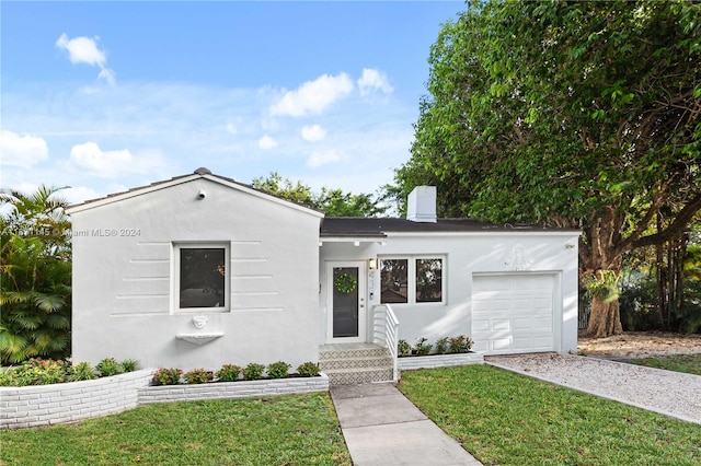 view of front facade with a garage and a front lawn