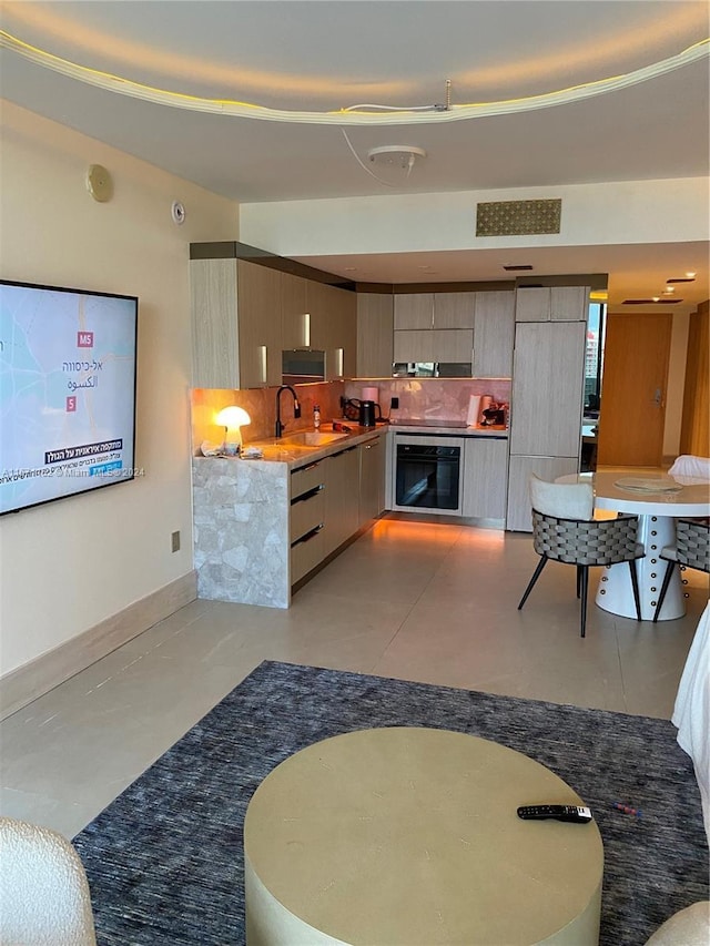 1850 S Ocean Dr Unit 3109, Hallandale Beach, FL 33009 - kitchen featuring backsplash, modern cabinets, a sink, and black oven