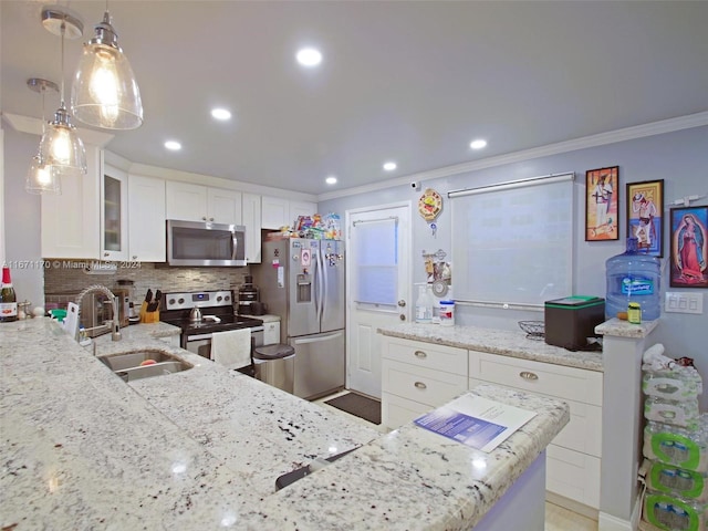 kitchen featuring hanging light fixtures, ornamental molding, white cabinetry, appliances with stainless steel finishes, and decorative backsplash