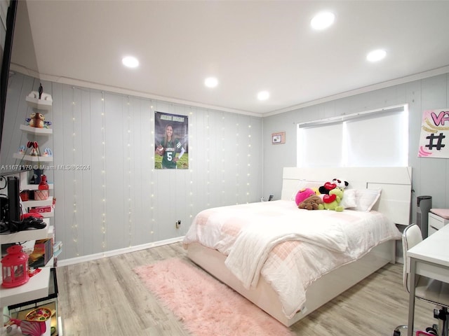 bedroom featuring light wood-type flooring and crown molding