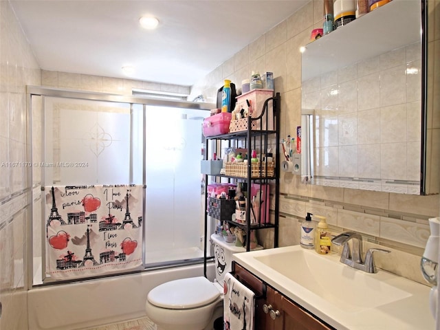 full bathroom with tile walls, tasteful backsplash, vanity, enclosed tub / shower combo, and toilet