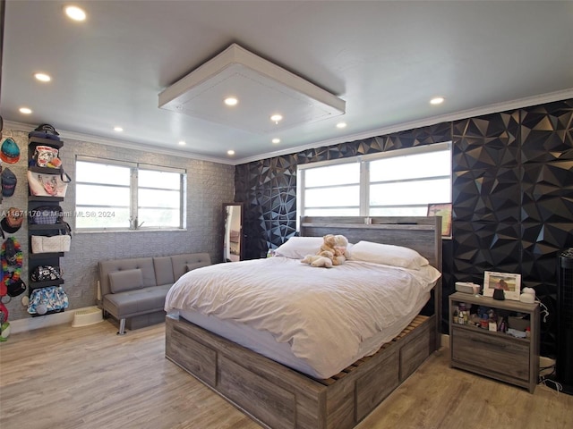 bedroom featuring multiple windows, crown molding, and hardwood / wood-style floors