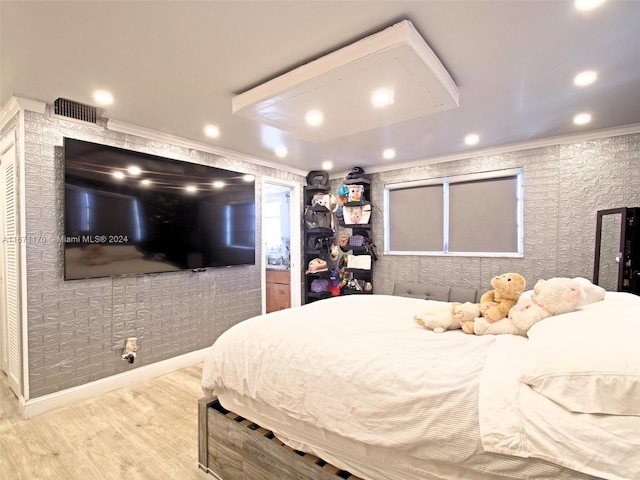 bedroom with hardwood / wood-style flooring and crown molding