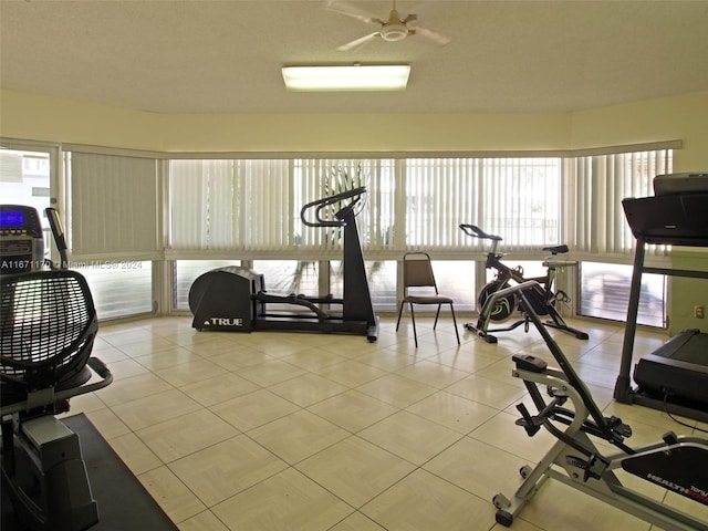 workout room with ceiling fan and light tile patterned flooring