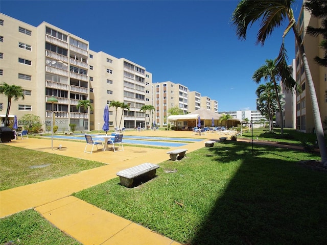 view of property's community with a patio, a pool, and a yard