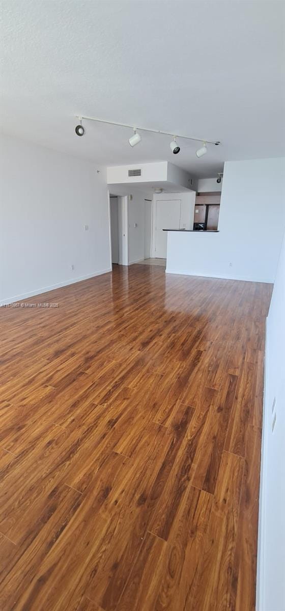 unfurnished living room with hardwood / wood-style flooring