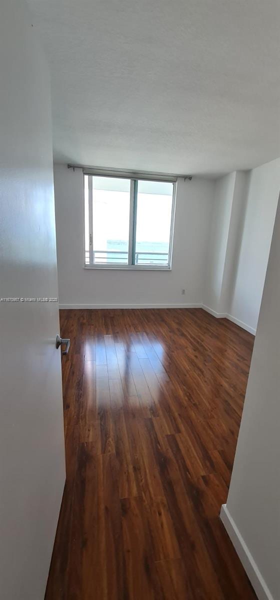 empty room featuring dark wood-type flooring