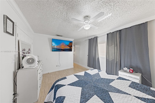 bedroom featuring a textured ceiling, light wood-type flooring, ceiling fan, and crown molding