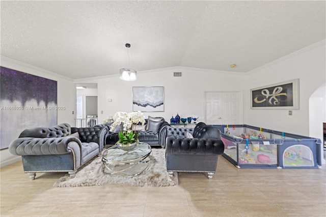 living room with ornamental molding, a textured ceiling, light tile patterned floors, and lofted ceiling