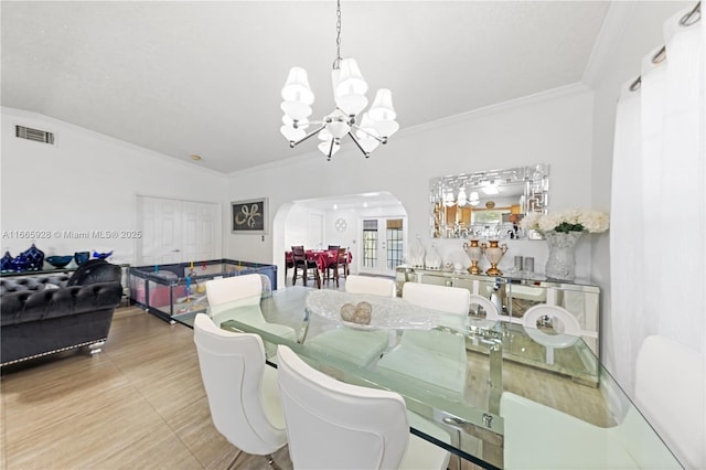 dining room featuring vaulted ceiling, crown molding, and a notable chandelier