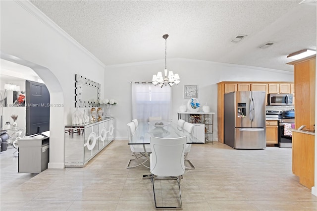 tiled dining space featuring a textured ceiling, an inviting chandelier, vaulted ceiling, and ornamental molding