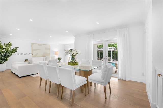 dining room featuring light hardwood / wood-style floors, french doors, and crown molding