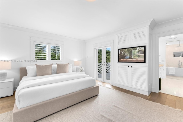 bedroom with access to outside, ornamental molding, wood-type flooring, french doors, and ensuite bathroom