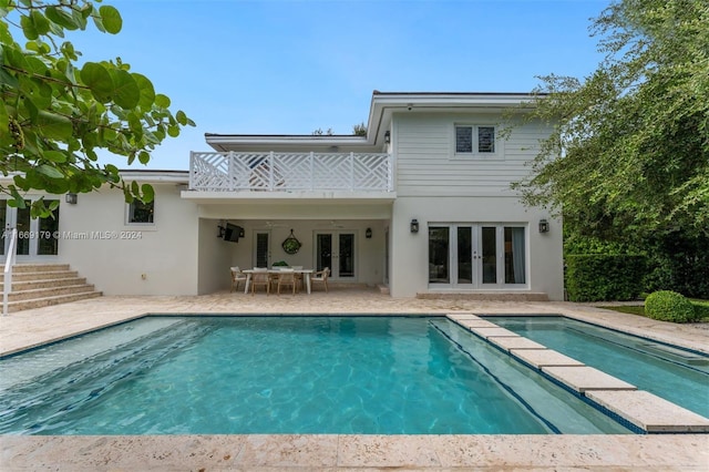 back of house with a balcony, a patio area, and french doors