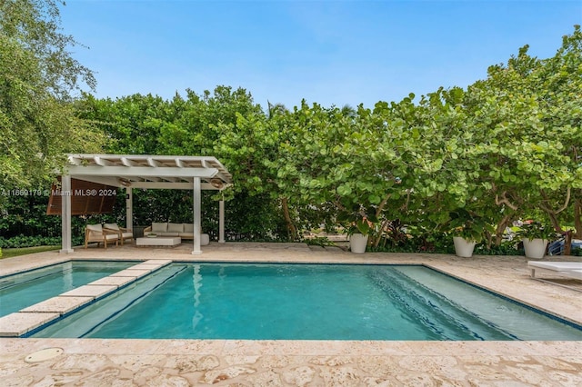 view of pool with a pergola, an outdoor living space, and a patio